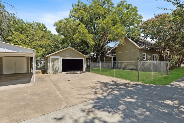 exterior space featuring a lawn, a garage, and an outdoor structure