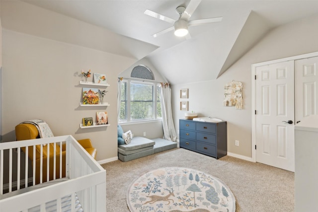 carpeted bedroom with a closet, ceiling fan, and vaulted ceiling