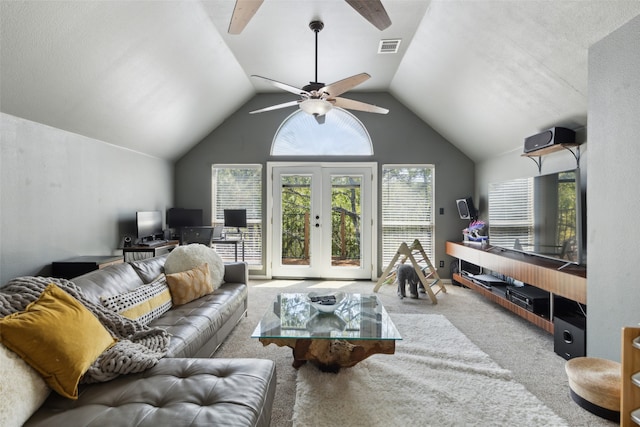 carpeted living room with french doors, ceiling fan, and vaulted ceiling