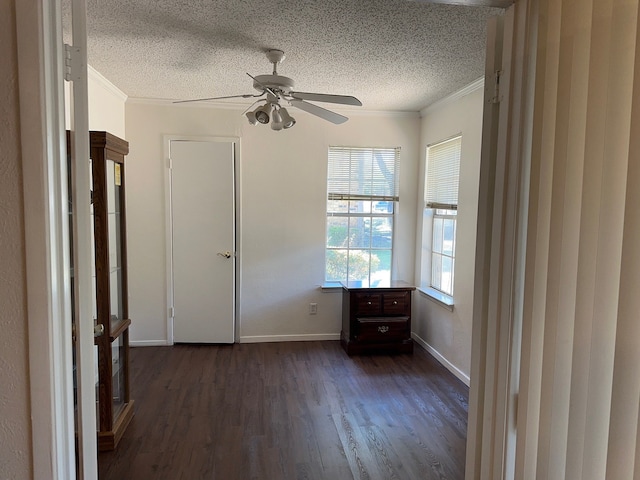 unfurnished bedroom with ceiling fan, dark hardwood / wood-style floors, a textured ceiling, and crown molding