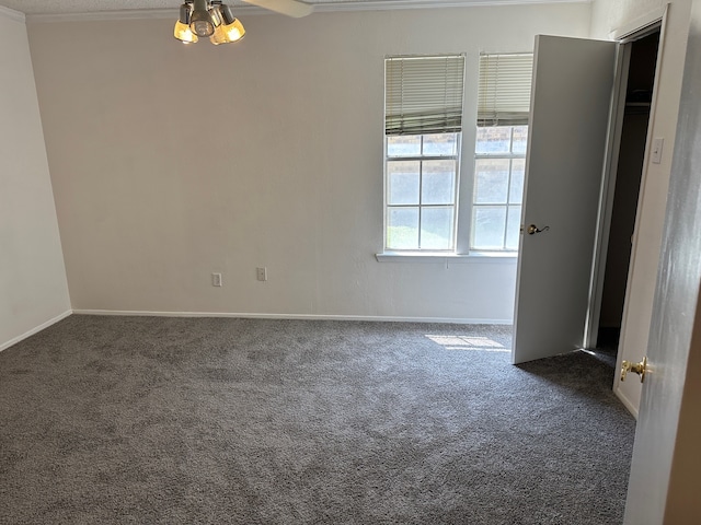 unfurnished room featuring dark carpet, crown molding, and ceiling fan