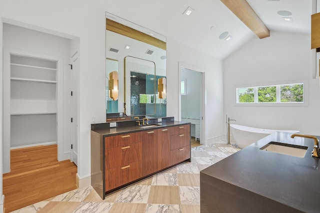 bathroom with vanity, built in features, lofted ceiling with beams, hardwood / wood-style flooring, and a bathing tub