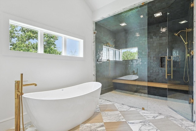 bathroom featuring shower with separate bathtub