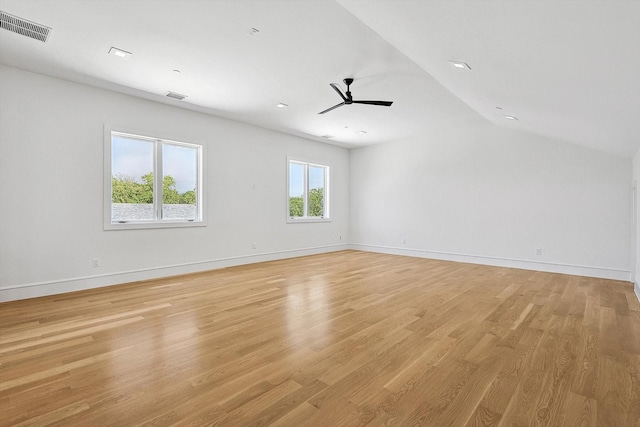 spare room with vaulted ceiling, ceiling fan, and light hardwood / wood-style floors