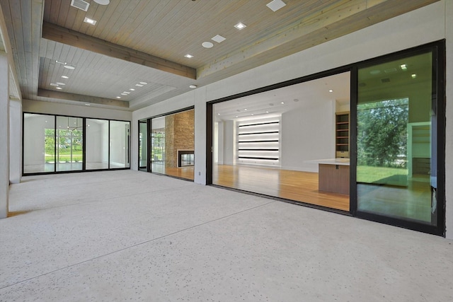 spare room with wood ceiling and a fireplace