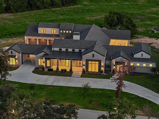 modern inspired farmhouse with covered porch and a front yard