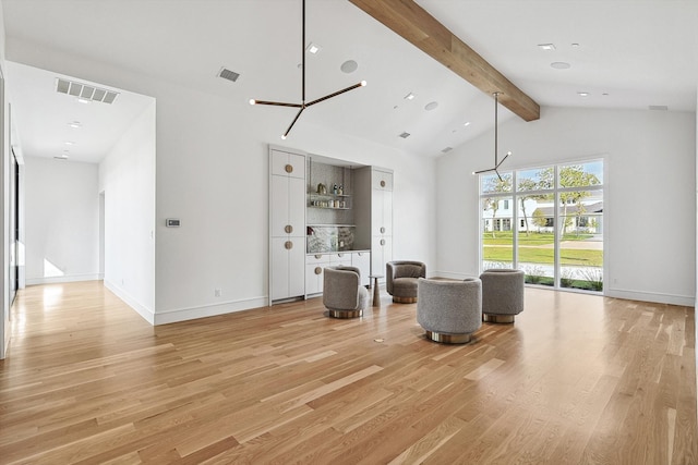 living room featuring light hardwood / wood-style floors, high vaulted ceiling, beamed ceiling, and a notable chandelier