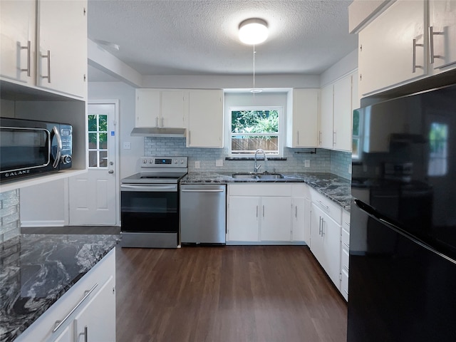 kitchen featuring dark hardwood / wood-style floors, dark stone countertops, tasteful backsplash, and black appliances