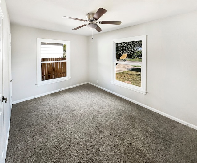 empty room featuring carpet flooring, ceiling fan, and a healthy amount of sunlight