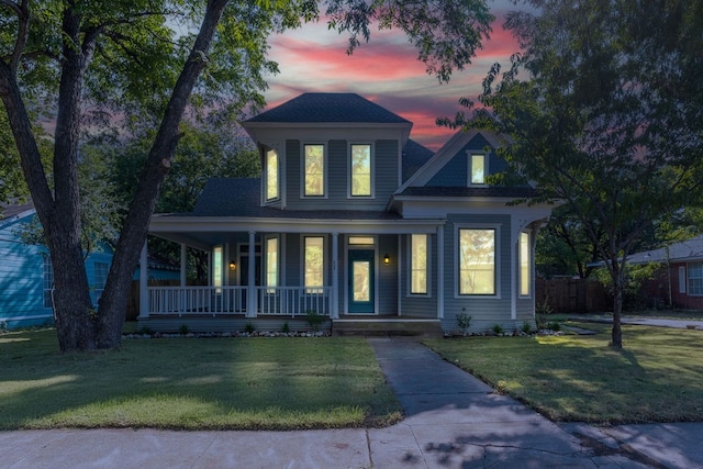 view of front facade with a lawn and covered porch