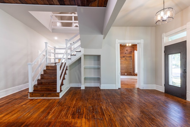 607 N Dallas St, Ennis, TX 75119 - foyer with baseboards, hardwood / wood-style floors, stairs, and an inviting chandelier