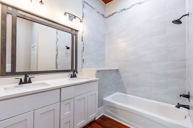 607 N Dallas St, Ennis, TX 75119 - full bathroom with  shower combination, wood finished floors, a sink, and double vanity