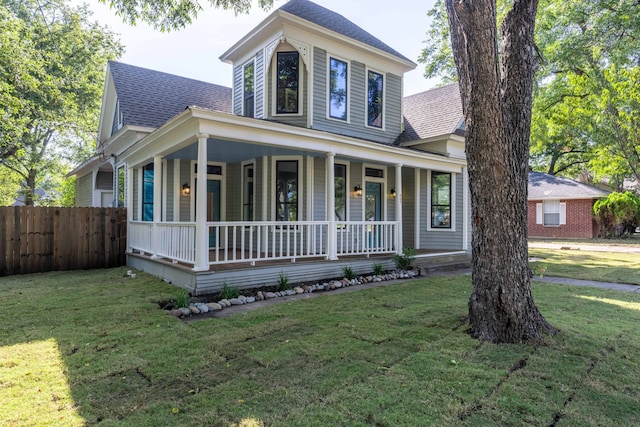 country-style home with a front yard and a porch