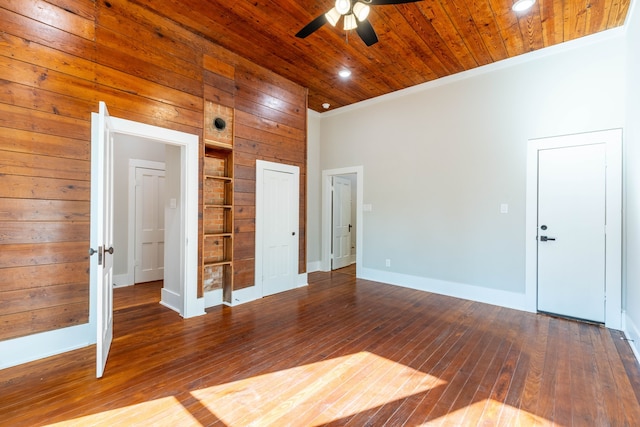 spare room with hardwood / wood-style flooring, wooden walls, and wood ceiling