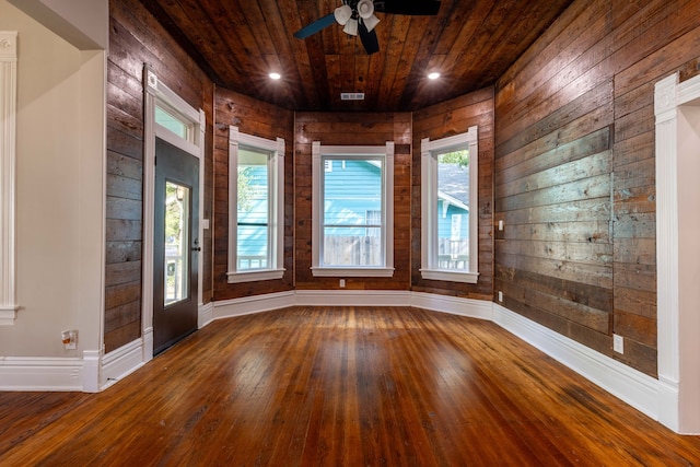 607 N Dallas St, Ennis, TX 75119 - unfurnished room with hardwood / wood-style floors, wooden ceiling, wooden walls, and ceiling fan