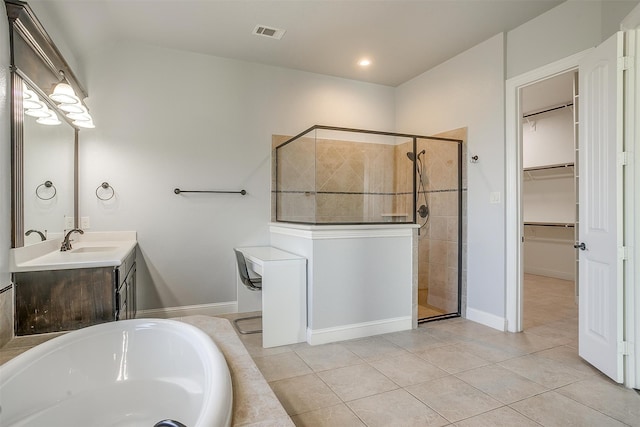 bathroom with shower with separate bathtub, vanity, and tile patterned flooring