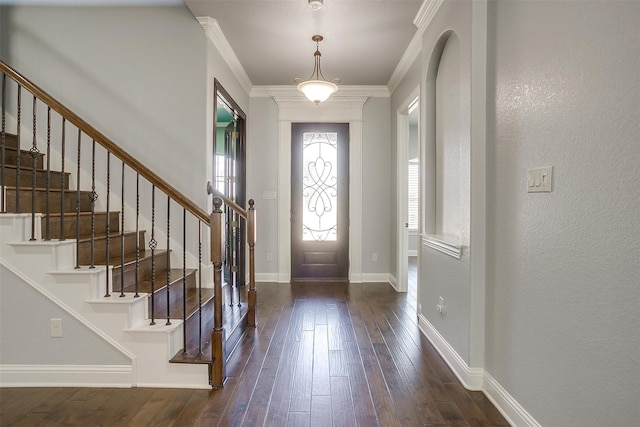 foyer entrance featuring ornamental molding and dark hardwood / wood-style flooring