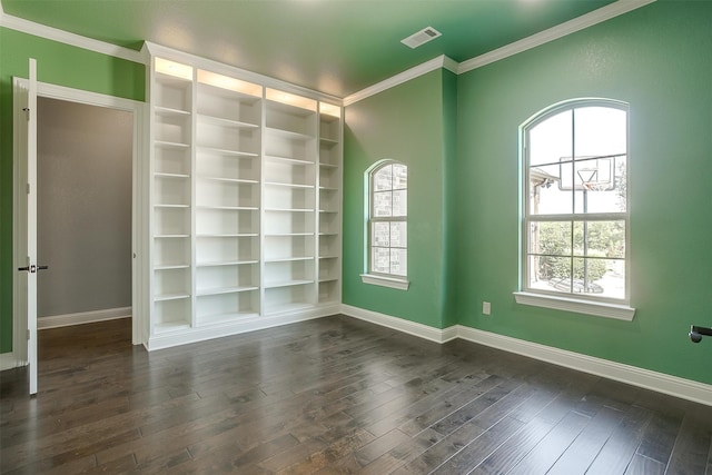 empty room featuring dark hardwood / wood-style flooring and ornamental molding