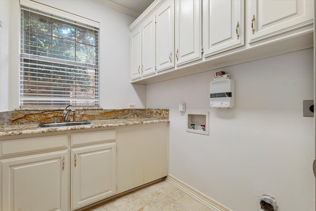 laundry room with washer hookup, crown molding, cabinet space, a sink, and baseboards