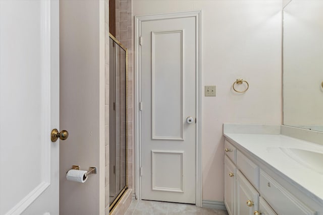 bathroom featuring a tile shower and vanity