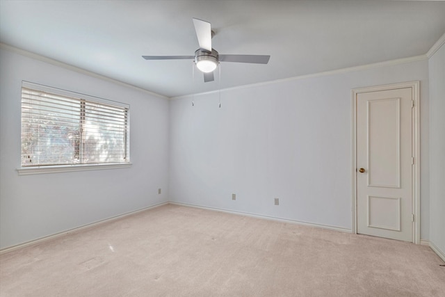 unfurnished room with crown molding, ceiling fan, baseboards, and light colored carpet