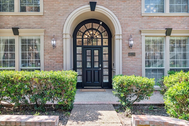 property entrance featuring brick siding