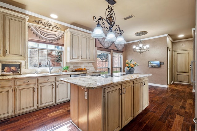 kitchen featuring light stone counters, black electric cooktop, a sink, a kitchen island, and pendant lighting