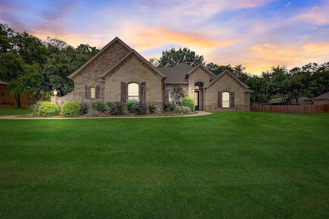 french country home featuring a lawn