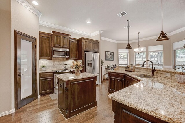 kitchen with light stone countertops, dark wood-type flooring, stainless steel appliances, and backsplash