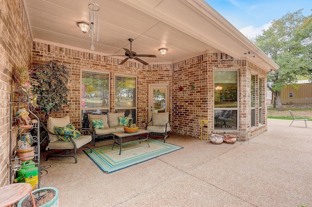 view of patio / terrace with ceiling fan and an outdoor living space