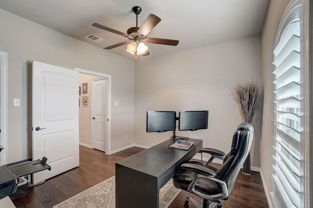 home office with ceiling fan and dark hardwood / wood-style floors