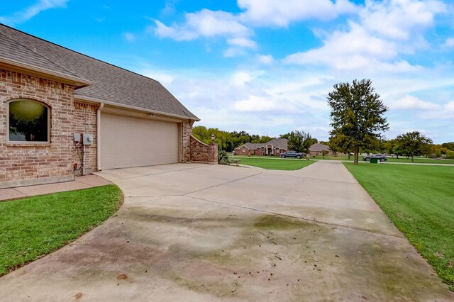 view of property exterior featuring a yard and a garage