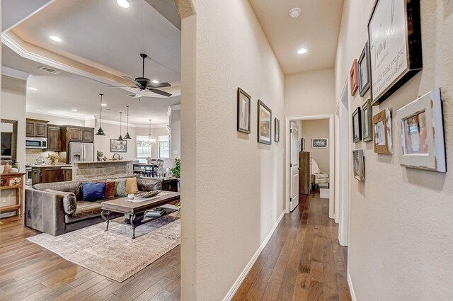 corridor featuring crown molding and wood-type flooring