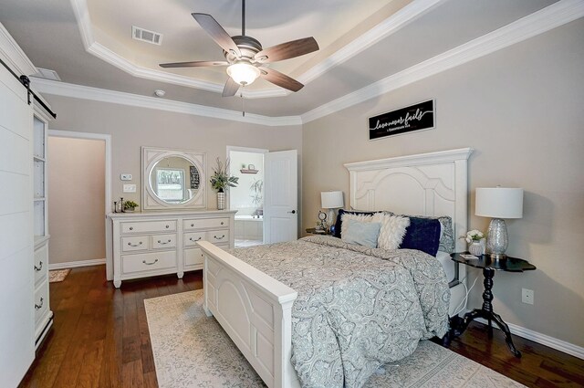 bedroom with a tray ceiling, dark hardwood / wood-style floors, ornamental molding, and ceiling fan