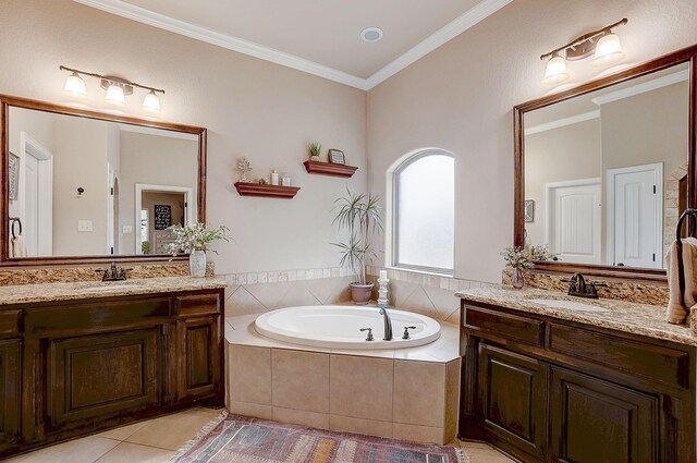 bathroom with tiled tub, vanity, ornamental molding, and tile patterned flooring