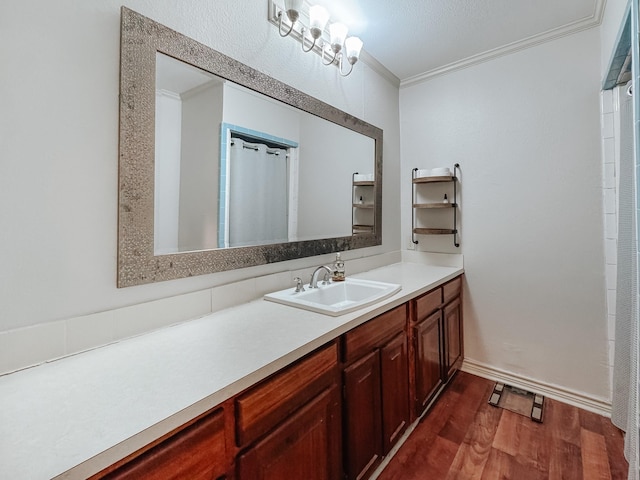 bathroom with wood-type flooring, vanity, and crown molding