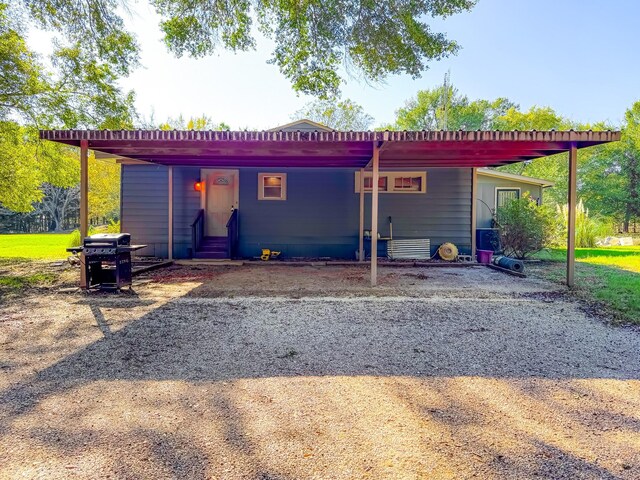 rear view of property with a carport