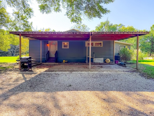 back of house with a carport