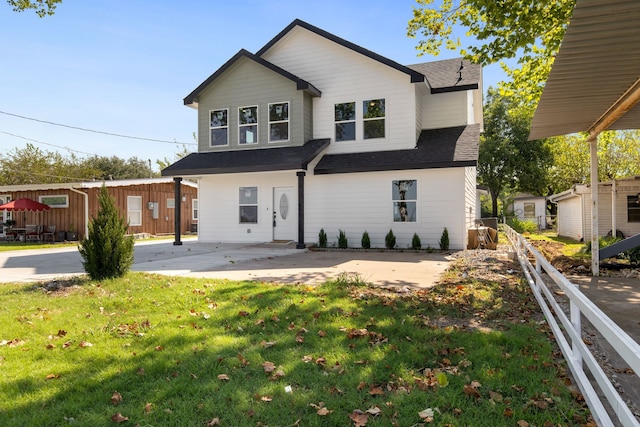 back of house featuring a patio and a yard