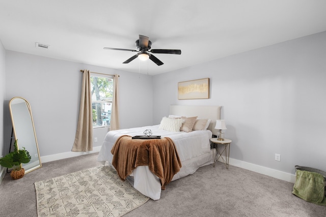 bedroom featuring light colored carpet and ceiling fan