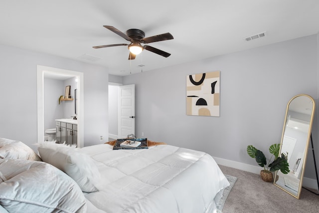 carpeted bedroom featuring ceiling fan and ensuite bathroom