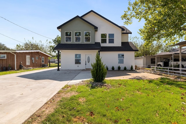 view of front of home featuring a front lawn and central AC