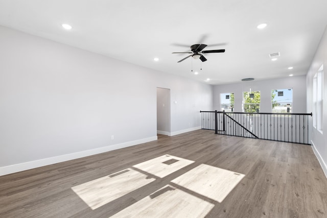 spare room with light wood-type flooring and ceiling fan