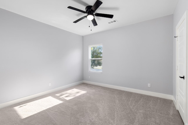 carpeted spare room featuring ceiling fan