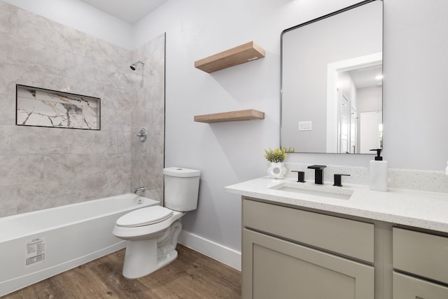 full bathroom featuring toilet, tiled shower / bath combo, vanity, and wood-type flooring