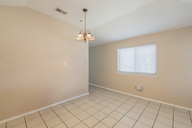 spare room with vaulted ceiling and a notable chandelier