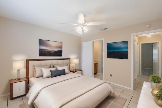 tiled bedroom with ensuite bathroom and ceiling fan