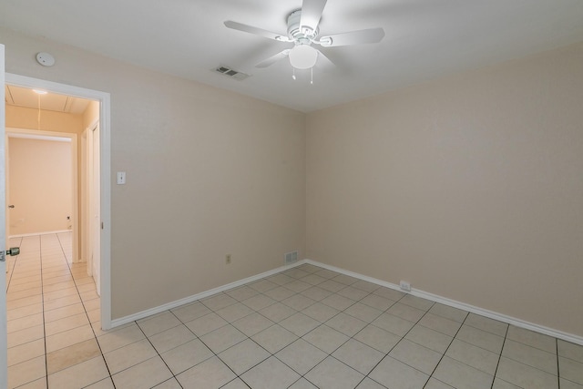 empty room with ceiling fan and light tile patterned floors