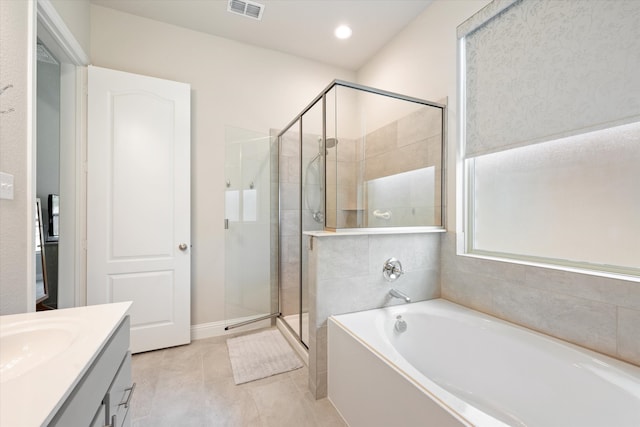 bathroom with tile patterned floors, vanity, and plus walk in shower