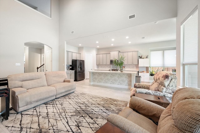 living room with a towering ceiling